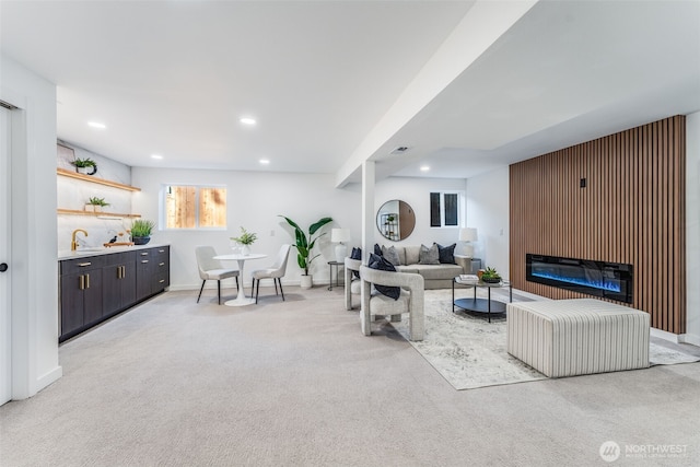 living room with recessed lighting, light carpet, visible vents, baseboards, and a glass covered fireplace