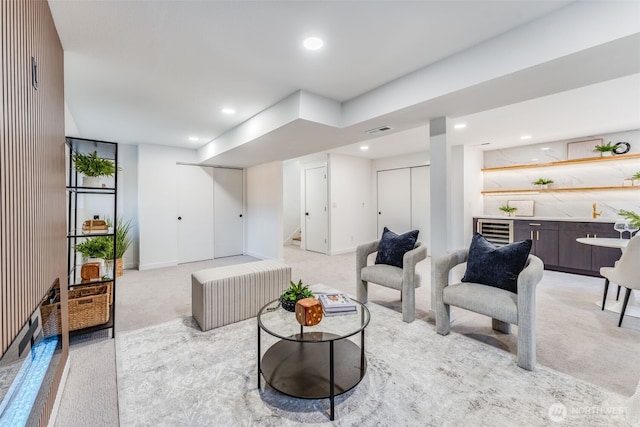 living room with wine cooler, recessed lighting, light colored carpet, visible vents, and stairs