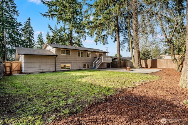 back of property featuring a patio, a lawn, and a fenced backyard