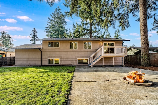 view of front facade with a fire pit, a patio, a front lawn, and fence