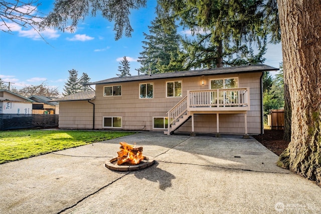 rear view of property with an outdoor fire pit, stairs, fence, a wooden deck, and a patio area