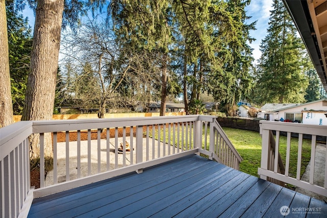 wooden terrace featuring a lawn