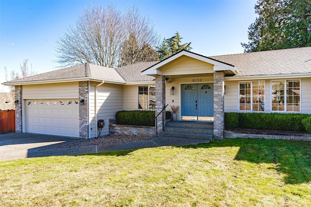 ranch-style home featuring a garage, driveway, a shingled roof, and a front yard