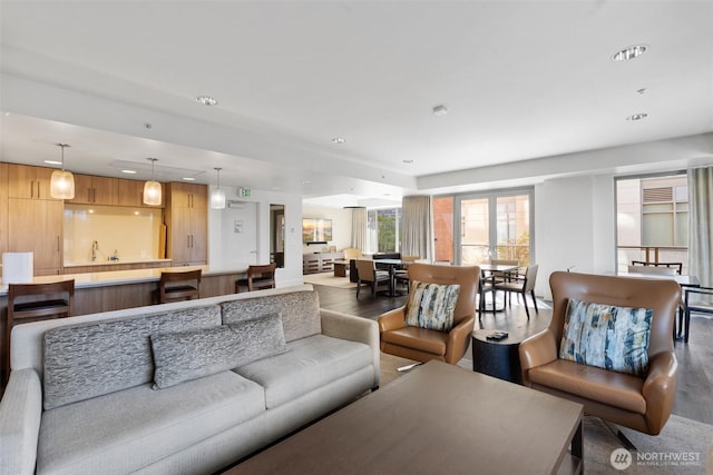 living room with wood finished floors and recessed lighting