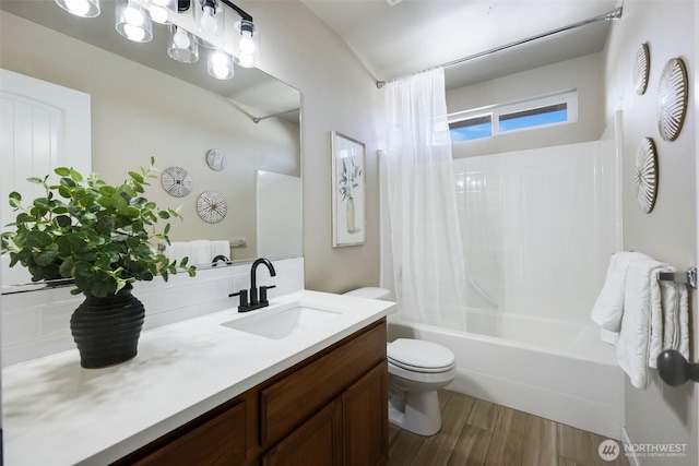 bathroom featuring vanity, shower / tub combo, wood finished floors, and toilet