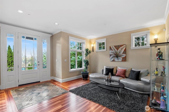 interior space featuring baseboards, recessed lighting, wood finished floors, and crown molding