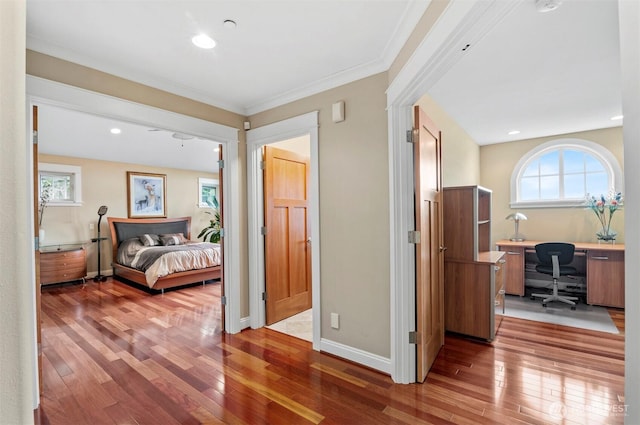 bedroom with crown molding, baseboards, hardwood / wood-style floors, and recessed lighting