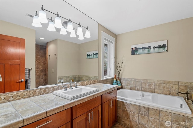 bathroom featuring a tile shower, a bath, and vanity