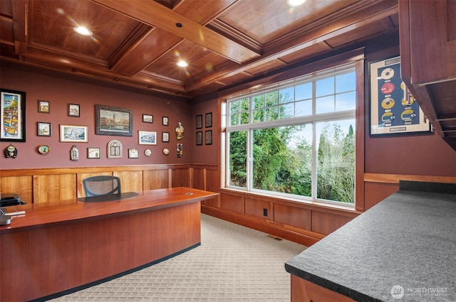 carpeted office space featuring wooden ceiling, coffered ceiling, visible vents, wainscoting, and beamed ceiling