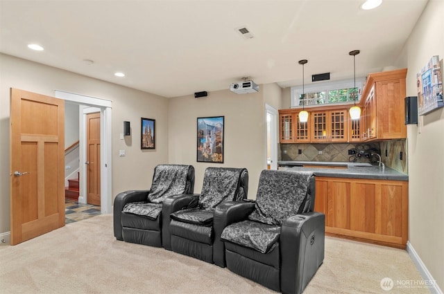 cinema featuring light carpet, baseboards, visible vents, a sink, and recessed lighting