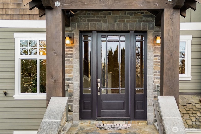 property entrance featuring stone siding