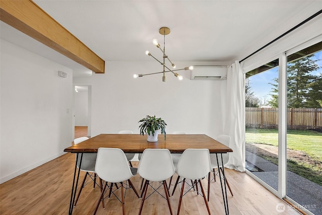 dining area with light wood finished floors, baseboards, a wall mounted air conditioner, an inviting chandelier, and beam ceiling