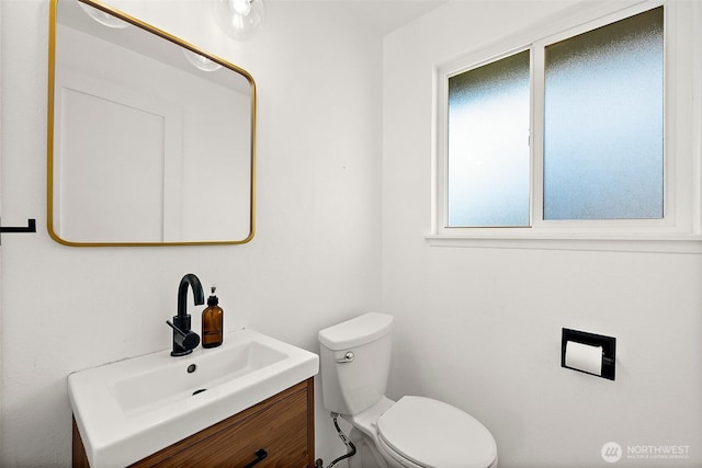 bathroom featuring toilet and vanity