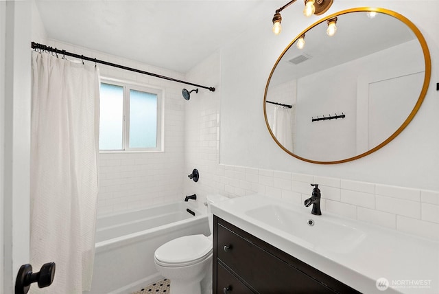 full bath with visible vents, toilet, shower / bath combination with curtain, vanity, and tile walls