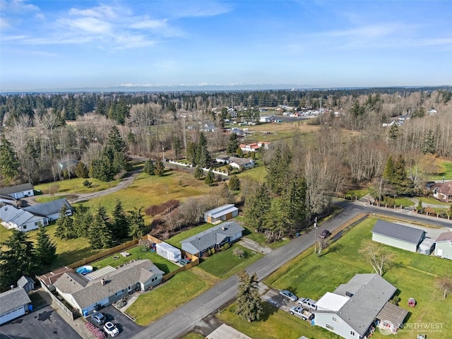 birds eye view of property featuring a wooded view