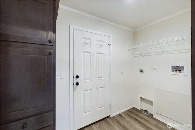 clothes washing area featuring washer hookup, light wood-style flooring, ornamental molding, electric dryer hookup, and laundry area