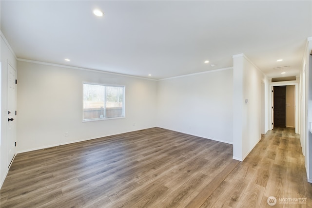 empty room with crown molding, baseboards, wood finished floors, and recessed lighting