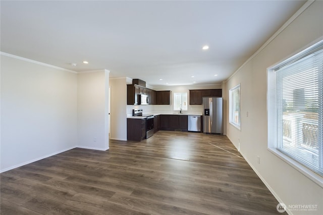 kitchen with dark brown cabinetry, plenty of natural light, appliances with stainless steel finishes, dark wood-type flooring, and light countertops