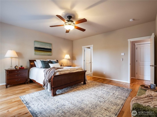 bedroom featuring baseboards, a ceiling fan, and light wood-style floors