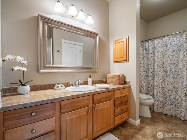 bathroom featuring tile patterned flooring, vanity, and toilet