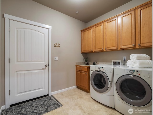 laundry room featuring cabinet space, baseboards, and washer and dryer