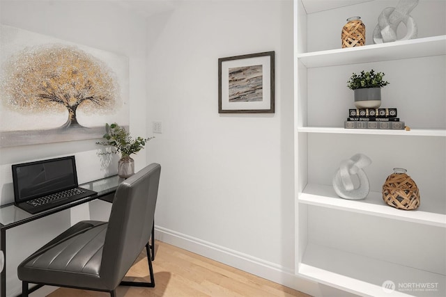 office area with baseboards and wood finished floors