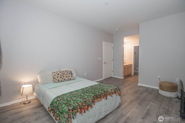 bedroom with wood finished floors and baseboards