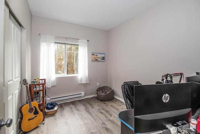 home office with a baseboard radiator, wood finished floors, and baseboards