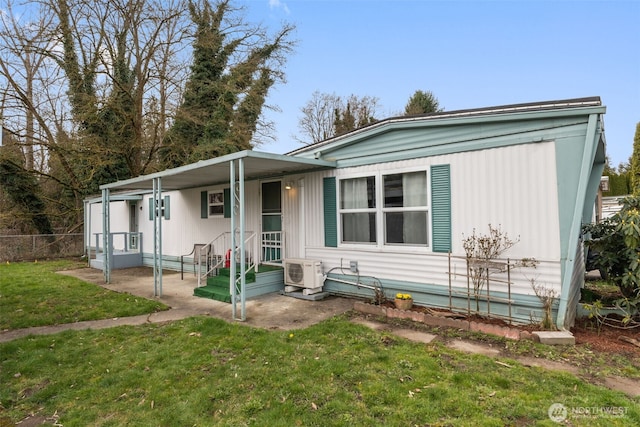 manufactured / mobile home with ac unit, a front yard, and fence