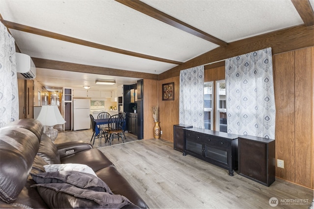 living area featuring lofted ceiling with beams, a wall mounted air conditioner, wood finished floors, and wood walls