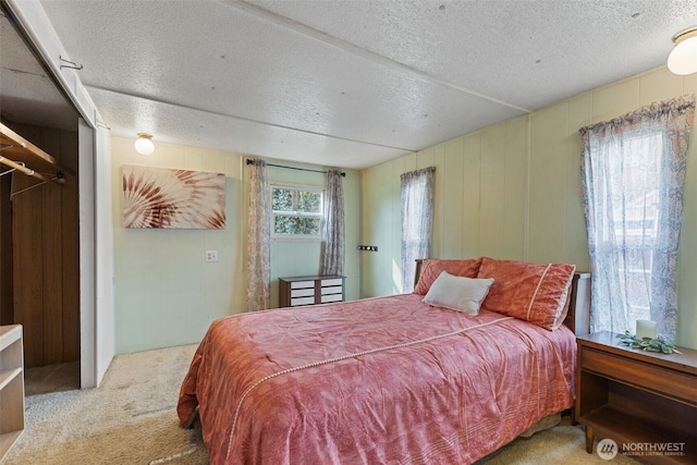 carpeted bedroom featuring a textured ceiling