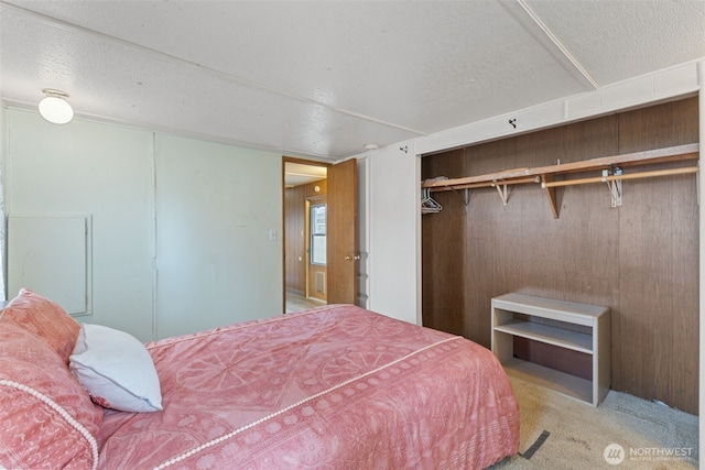 bedroom with carpet and a textured ceiling