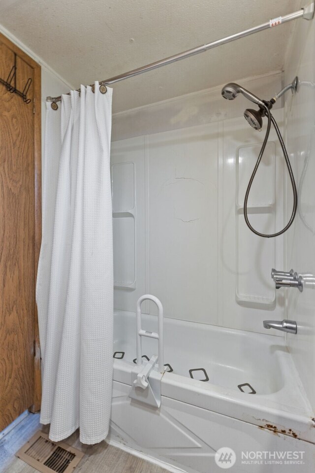 full bath with shower / tub combo and visible vents