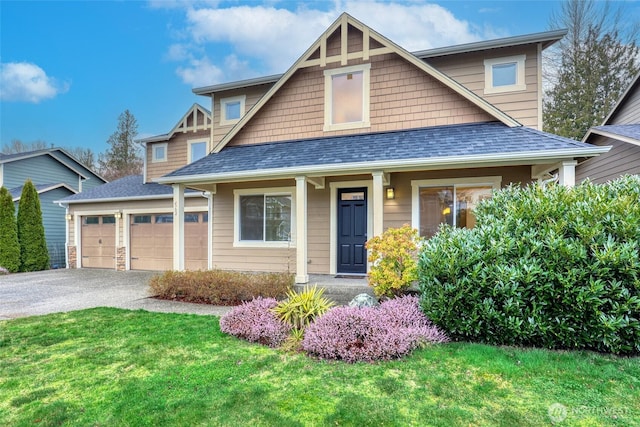 view of front of house featuring an attached garage, a shingled roof, aphalt driveway, and a front yard