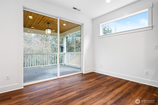 empty room with baseboards, visible vents, wood finished floors, and recessed lighting