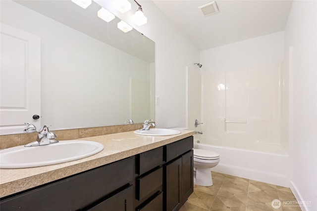 full bath with toilet, double vanity, a sink, and visible vents