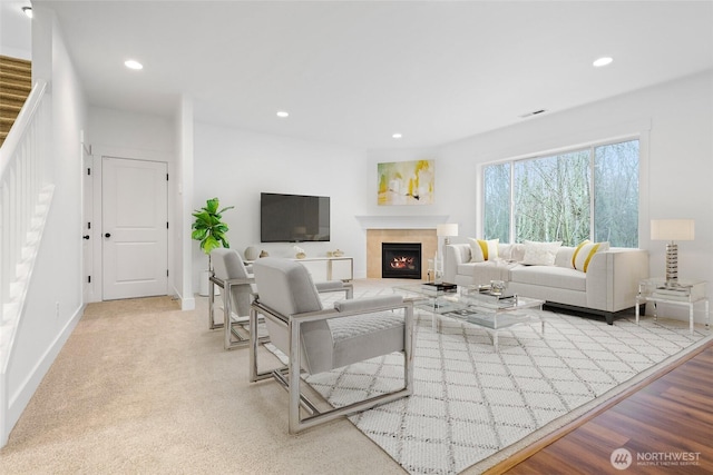 living room featuring a fireplace, baseboards, and recessed lighting