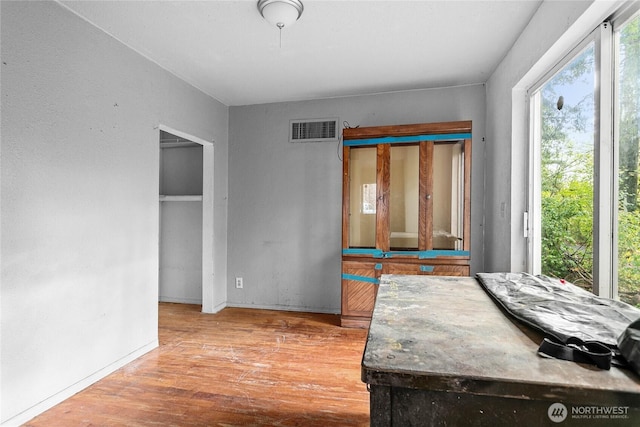 dining area with baseboards, visible vents, and wood finished floors