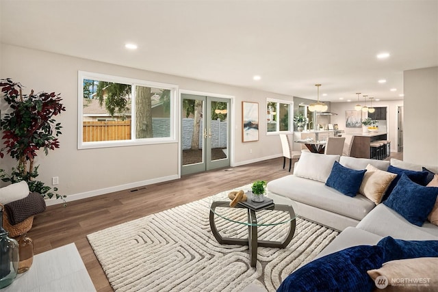 living area featuring french doors, wood finished floors, and recessed lighting