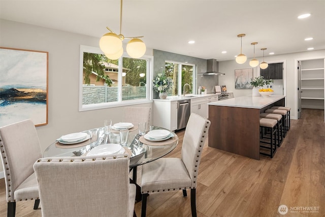 dining room with light wood-type flooring and recessed lighting