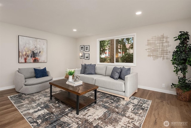 living room featuring baseboards, wood finished floors, and recessed lighting