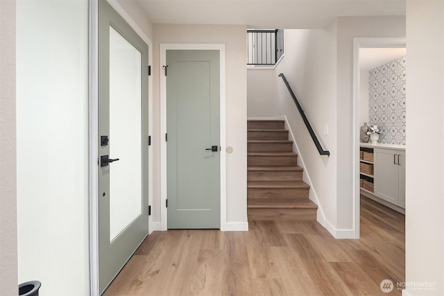 stairs featuring baseboards and wood finished floors