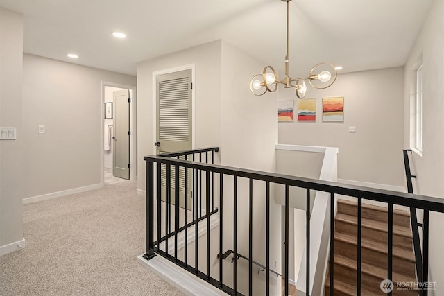 hall with a chandelier, recessed lighting, carpet floors, an upstairs landing, and baseboards