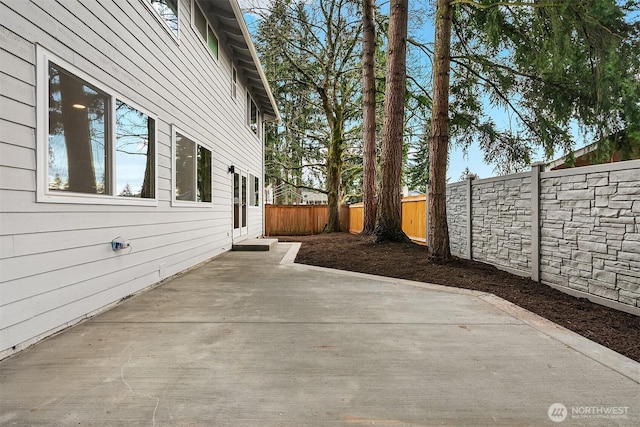 view of side of property with a fenced backyard and a patio