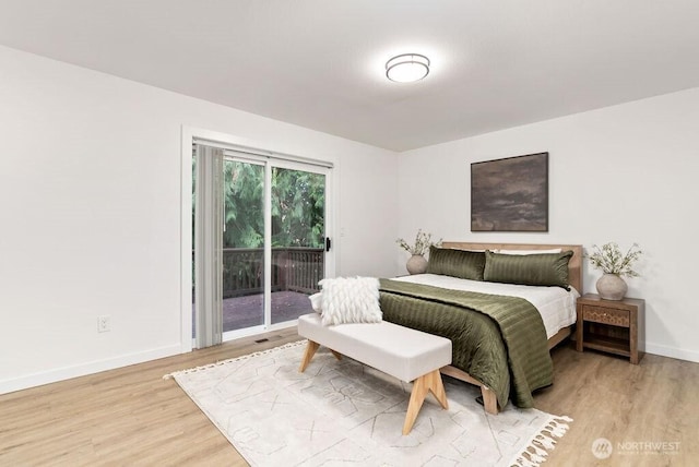 bedroom featuring baseboards, access to outside, and light wood-style floors