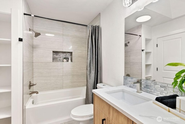 bathroom with tasteful backsplash, shower / bath combo, vanity, and toilet