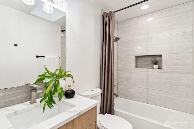 bathroom featuring shower / tub combo, vanity, and toilet