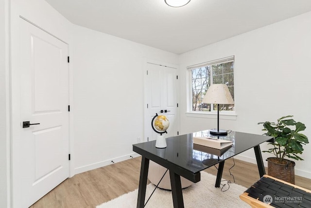 home office with light wood finished floors and baseboards