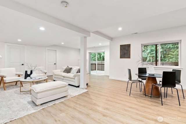 living area featuring baseboards, light wood-style flooring, and recessed lighting