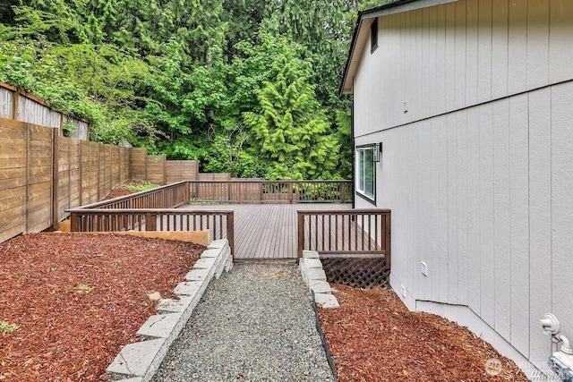 view of yard featuring a fenced backyard and a wooden deck